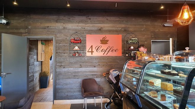 The wood-clad corner of the room with seating and the cake cabinet